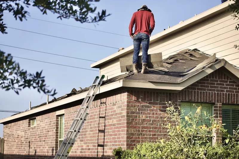 Professional roofer working on a residential roof in Hunchberger Corners